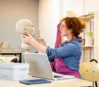 Woman working in pottery studio workshop sculpting human head. Woman working in pottery studio workshop sculpting human head.